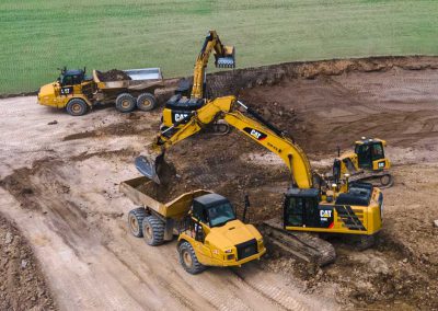 excavator and two dump trucks